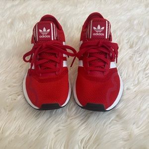 Red and white kids Adidas swift run tennis shoe.